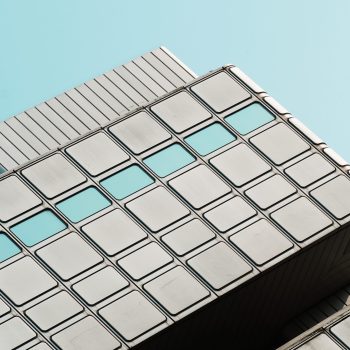 low-angle-view-modern-building-against-clear-blue-sky