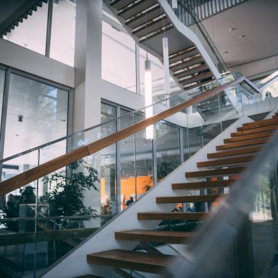 A modern room with a wooden staircase during daytime