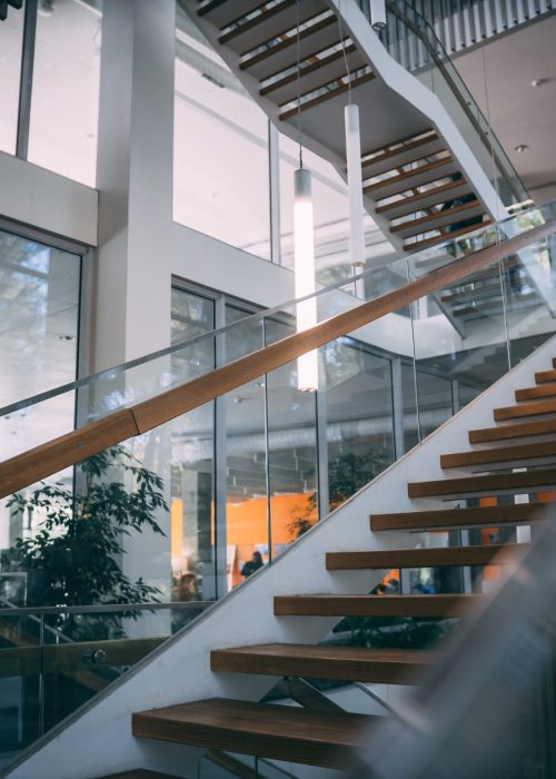A modern room with a wooden staircase during daytime