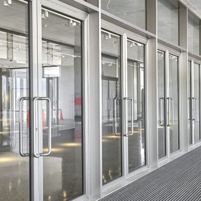 Revolving doors. The facade of a modern shopping center or station, an airport with revolving doors. Modern office entrance glass revolving door